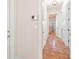 Hallway with tile flooring, white walls, and multiple doors leading to different rooms at 38230 Yale Cir, Leesburg, FL 34788