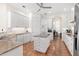 Bright kitchen featuring white cabinetry, an island with granite countertops and stainless steel appliances at 38230 Yale Cir, Leesburg, FL 34788