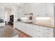 Bright kitchen featuring white cabinetry with long countertops and tile backsplash at 38230 Yale Cir, Leesburg, FL 34788