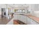 Bright kitchen featuring granite countertops, white cabinets and a view of the lake at 38230 Yale Cir, Leesburg, FL 34788
