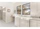 Bright laundry room with a washer, dryer, utility sink, cabinets, and outdoor views at 38230 Yale Cir, Leesburg, FL 34788