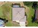Overhead view of a home featuring a spacious backyard, a pool enclosure, and a large driveway at 5009 Harbor Hts, Lady Lake, FL 32159