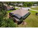 Aerial view of the home's backyard with a screened-in lanai and manicured landscaping at 5009 Harbor Hts, Lady Lake, FL 32159