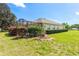 Lush backyard showcasing a screened-in lanai and mature landscaping at 5009 Harbor Hts, Lady Lake, FL 32159