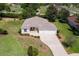 Charming home with a well-maintained lawn, manicured landscaping, and a welcoming two-car garage at 5009 Harbor Hts, Lady Lake, FL 32159