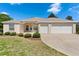 Charming single-story home featuring a well-maintained lawn and an attached two-car garage at 5009 Harbor Hts, Lady Lake, FL 32159