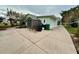 Large backyard patio area with storage shed and sitting bench at 558 Saint Andrews Blvd, The Villages, FL 32159