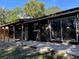 This is a cozy back porch with wooden beams that is connected to a glass sliding door entrance at 11 The Crescent, Minneola, FL 34715