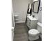 Bathroom offers new vanity, stylish mirror, decorative ladder, and a modern toilet at 11 The Crescent, Minneola, FL 34715