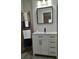 Bathroom features new vanity, rectangular mirror, decorative ladder, and plenty of cabinet storage at 11 The Crescent, Minneola, FL 34715