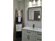 Bathroom with modern vanity, black faucet, square mirror, and a decorative towel ladder displaying towels at 11 The Crescent, Minneola, FL 34715