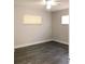 Bedroom features neutral paint, new vinyl floors, a ceiling fan, and a double-hung window at 11 The Crescent, Minneola, FL 34715