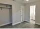 Bedroom displays a neutral paint, new vinyl floors, view to bathroom, and ample closet space at 11 The Crescent, Minneola, FL 34715
