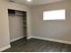 Bedroom with new floors, closet with shelving, and new window at 11 The Crescent, Minneola, FL 34715