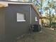 The exterior of the home has a modern AC unit and a clean, neutral color scheme at 11 The Crescent, Minneola, FL 34715