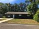 Charming single-story home with manicured lawn, sidewalk and driveway leading to the front door at 11 The Crescent, Minneola, FL 34715