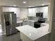 Modern kitchen with white cabinets, stainless steel appliances, and quartz countertops at 11 The Crescent, Minneola, FL 34715