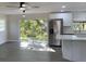 Open kitchen and living space with stainless steel appliances and backyard views at 11 The Crescent, Minneola, FL 34715