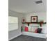 Bright living room features a built-in bench, floating shelf and modern gray flooring at 11 The Crescent, Minneola, FL 34715