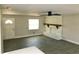Bright living room featuring a decorative fireplace, a ceiling fan, wood-look floors, and natural light from the window at 11 The Crescent, Minneola, FL 34715