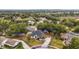An aerial view of a single-Gathering home featuring a well-manicured lawn and mature trees at 14701 Timucua Pl, Clermont, FL 34711