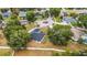 Aerial view showcases the home surrounded by mature trees, landscaping, and a well-maintained neighborhood at 14701 Timucua Pl, Clermont, FL 34711