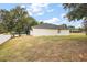 A spacious backyard featuring healthy lawn and privacy fence, perfect for outdoor enjoyment at 14701 Timucua Pl, Clermont, FL 34711