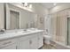 Bright bathroom featuring a large mirror, white vanity, and a shower-tub combination at 955 Ladera Ranch Rd, Kissimmee, FL 34759