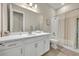 Bright bathroom featuring a large mirror, white vanity, and a shower-tub combination at 955 Ladera Ranch Rd, Kissimmee, FL 34759