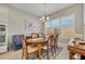 Charming dining area with an oval wooden table, classic chairs, and a large window at 955 Ladera Ranch Rd, Kissimmee, FL 34759