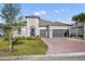 Beautiful home featuring a two-car garage, brick driveway, and well-kept lawn at 955 Ladera Ranch Rd, Kissimmee, FL 34759