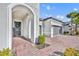 Inviting front entrance with brick walkway and arched doorway at 955 Ladera Ranch Rd, Kissimmee, FL 34759