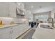 Modern kitchen with stainless steel appliances, white cabinets, quartz countertops, backsplash and breakfast area at 955 Ladera Ranch Rd, Kissimmee, FL 34759