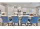 Modern kitchen with a large island, stylish blue chairs and stainless steel appliances at 955 Ladera Ranch Rd, Kissimmee, FL 34759