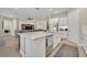 Bright kitchen features a center island with quartz countertops, stainless steel appliances, and white cabinetry at 955 Ladera Ranch Rd, Kissimmee, FL 34759