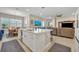 Bright open kitchen features a center island with quartz countertops, stainless steel appliances, and modern lighting at 955 Ladera Ranch Rd, Kissimmee, FL 34759