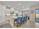 Bright, open kitchen with a large central island, stylish seating, and natural light at 955 Ladera Ranch Rd, Kissimmee, FL 34759