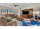 Comfortable living room featuring a large sectional sofa, entertainment center, and natural light at 955 Ladera Ranch Rd, Kissimmee, FL 34759