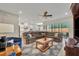 Bright living room featuring a large sectional sofa and entertainment center with an open concept to the kitchen at 955 Ladera Ranch Rd, Kissimmee, FL 34759