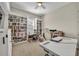 Bright office space with built-in bookshelves, multiple windows, and neutral decor at 955 Ladera Ranch Rd, Kissimmee, FL 34759