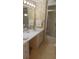 Cozy bathroom featuring a vanity and walk-in shower at 103 Fountain Cv, Leesburg, FL 34748
