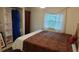 Comfortable bedroom featuring a large window and closet at 103 Fountain Cv, Leesburg, FL 34748