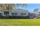 Charming single-story home with white siding, a landscaped yard, and a covered porch, perfect for relaxing outdoors at 103 Fountain Cv, Leesburg, FL 34748