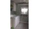 Functional laundry room with washer, dryer, shelves and window AC unit at 103 Fountain Cv, Leesburg, FL 34748