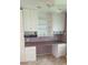 Functional office space with custom built-in desk, cabinetry, and shelving perfect for work from home at 103 Fountain Cv, Leesburg, FL 34748
