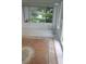 Bright sun room features tile flooring, windows, and serene views of the water at 103 Fountain Cv, Leesburg, FL 34748