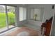 Sun-filled room with large windows overlooking the green yard and a vintage style rug at 103 Fountain Cv, Leesburg, FL 34748