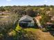 Aerial view of a home with a screened porch in a grassy area at 1063 Mesa Verde Ct, Clermont, FL 34711