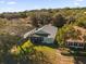 An aerial view of the home featuring mature trees on a well-maintained lot at 1063 Mesa Verde Ct, Clermont, FL 34711