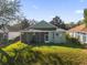Backyard of home with a screened-in patio and lush green lawn at 1063 Mesa Verde Ct, Clermont, FL 34711